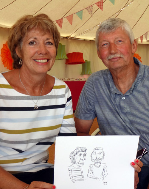 garden party guests with live caricature drawing in marquee
