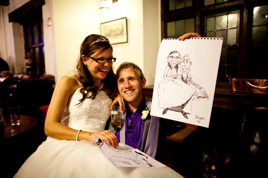 bride and groom with their live caricature drawing, shrewsbury wedding